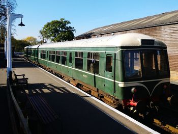 Train at railroad station against sky