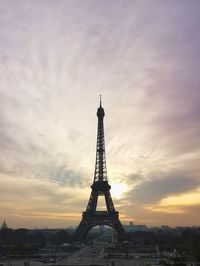 Eiffel tower against cloudy sky