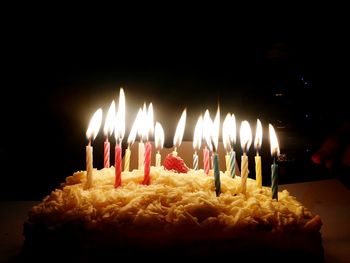 Lit candle in dark room