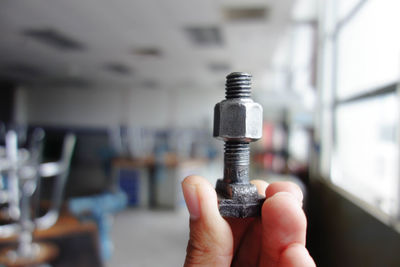 Close-up of man working on metal