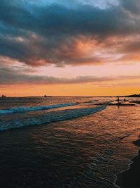 Scenic view of beach against sky during sunset
