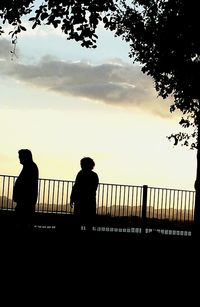 Silhouette of people looking at sunset