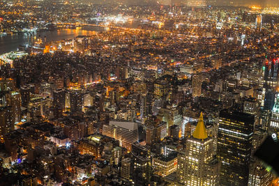 High angle view of city lit up at night