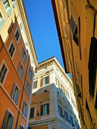 Low angle view of residential building against blue sky