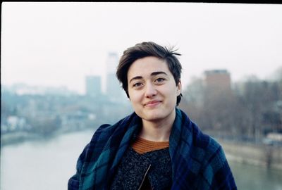 Portrait of smiling woman against sky