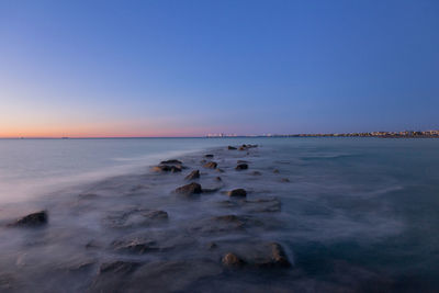 Scenic view of sea against clear blue sky