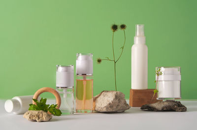 A set of cosmetics products with natural materials on a green background. natural organic cosmetic.