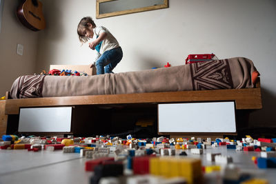 Boy playing with toy blocks at home