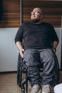 Portrait of young man sitting on chair