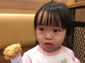 Close-up of thoughtful girl having food in restaurant