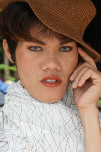 Close-up portrait of young man wearing hat