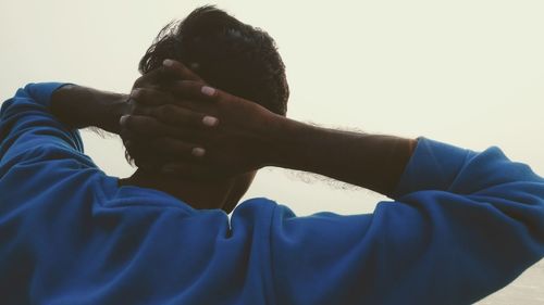 Close-up of boy holding blue hand