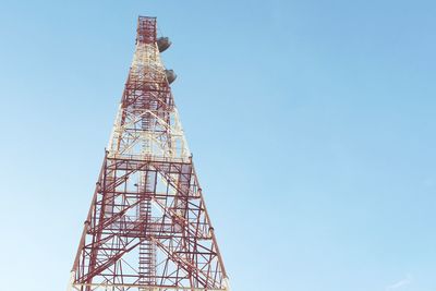 Low angle view of communications tower against sky