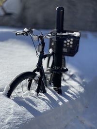 Close-up of bicycle on snow covered field