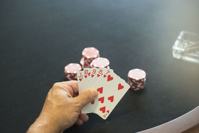 Close-up of man playing poker on table