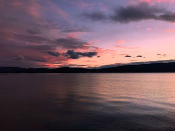 Scenic view of sea against dramatic sky during sunset