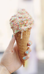 Close-up of hand holding ice cream cone