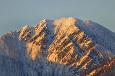 Scenic view of snowcapped mountains against clear sky