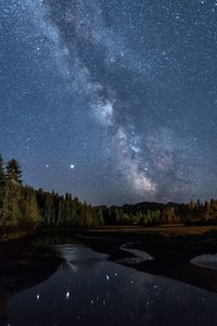 Scenic view of lake against sky at night