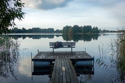 Pier on lake against sky