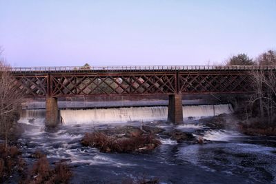 Bridge over river against clear sky