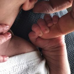 Close-up of father holding baby hand