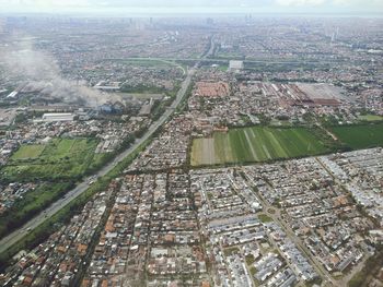 High angle view of crowd by river against buildings in city