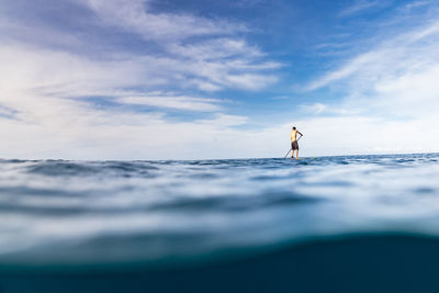 Man standing on beach against sky