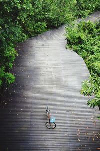 High angle view of bicycle on boardwalk in park