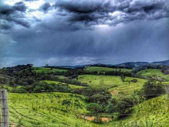 Scenic view of green landscape against sky