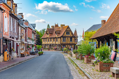 Street amidst buildings against sky in city