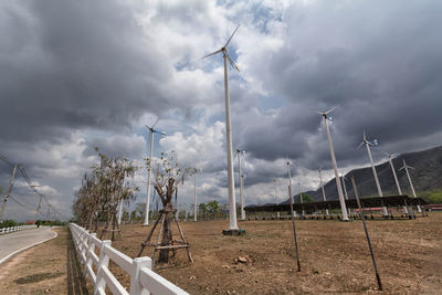 Wind turbines on land against sky