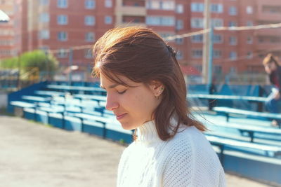 Portrait of beautiful young woman in city