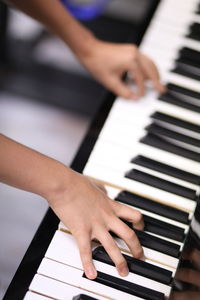 Midsection of man playing piano