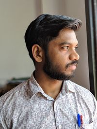 Close-up of man looking away at home