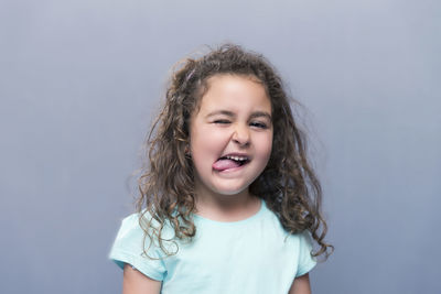 Portrait of smiling girl against white background