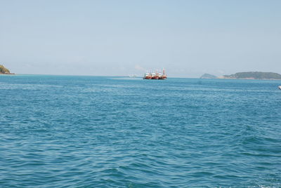 Boat sailing in sea against sky