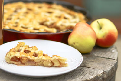 Close-up of pie and apples on table