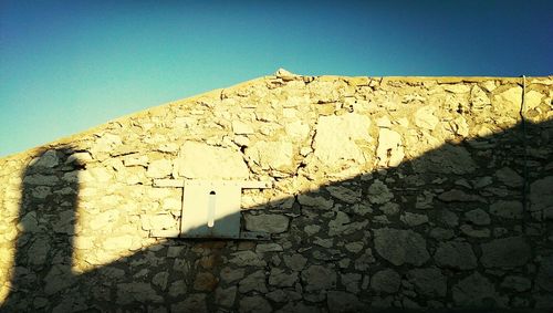 Low angle view of built structure against clear blue sky