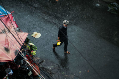 High angle view of man holding umbrella in city
