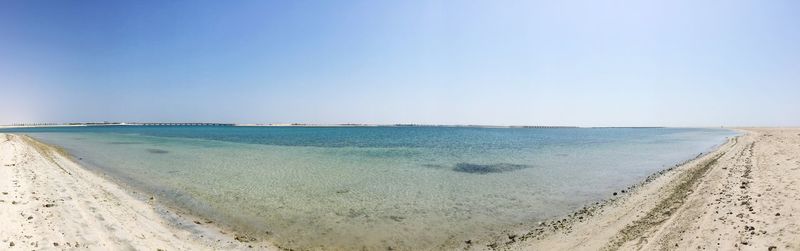 View of calm beach against clear sky