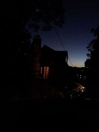 Low angle view of illuminated buildings against sky at night