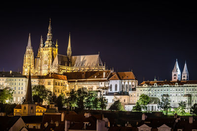 Low angle view of buildings against sky at night