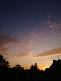 Low angle view of silhouette trees against sky during sunset