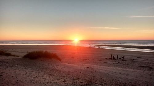 Scenic view of beach against sky during sunset