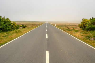 Empty road against clear sky