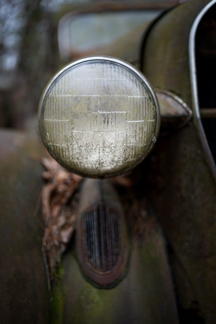 CLOSE-UP OF RUSTY CAR ON METAL