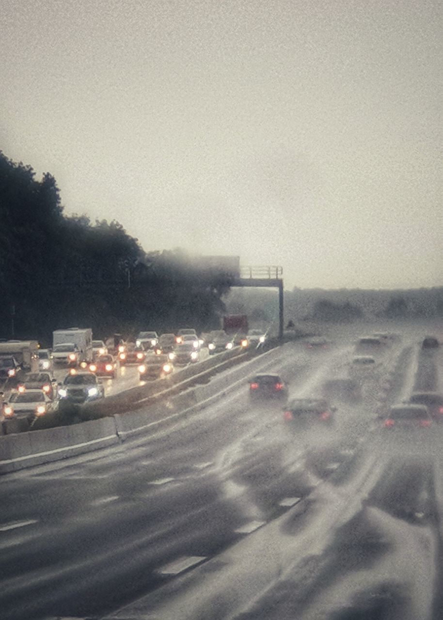 TRAFFIC ON ROAD AGAINST SKY