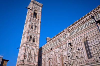 Low angle view of historic building against clear blue sky