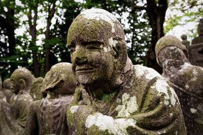 Statue against trees